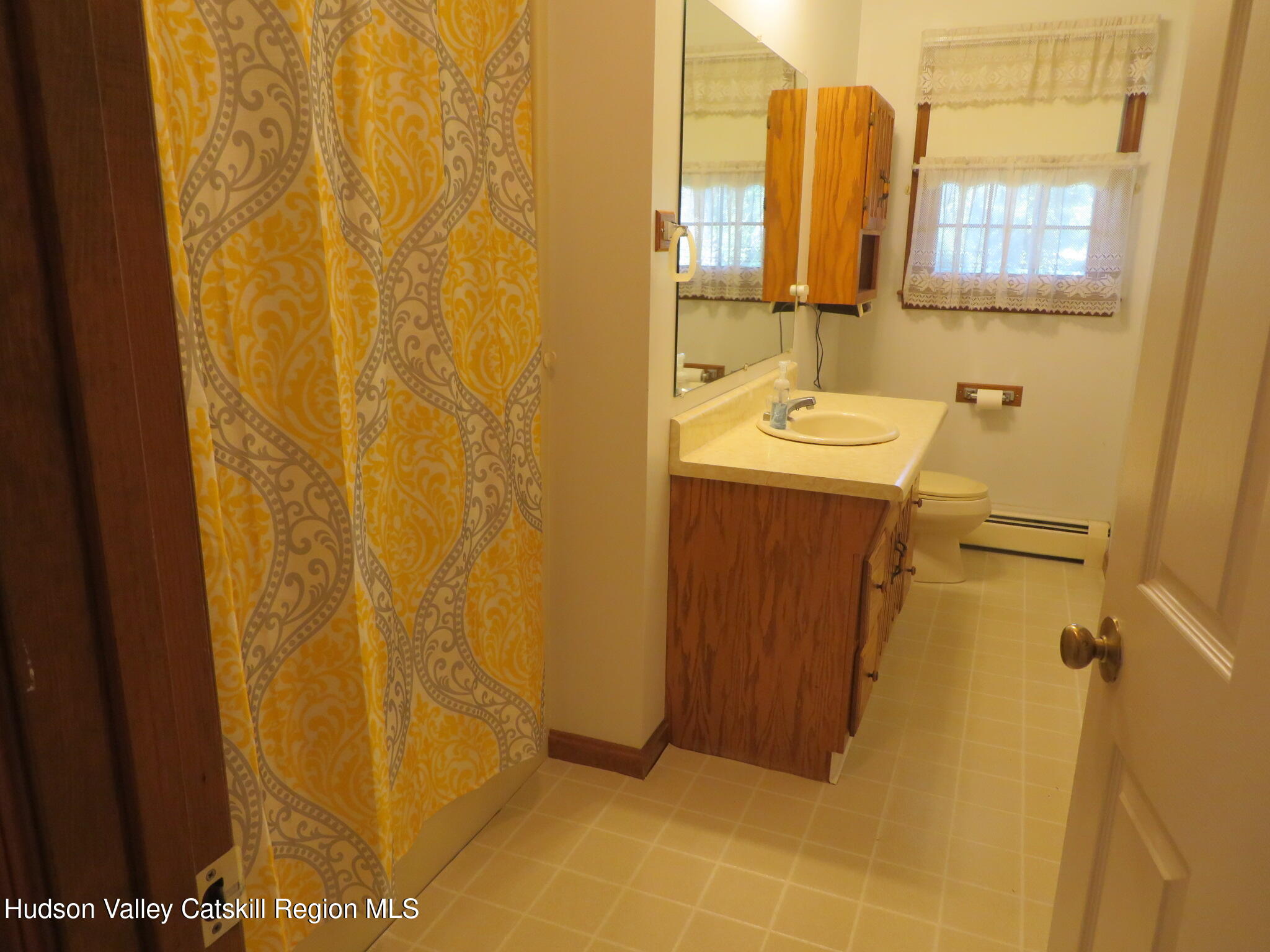 89 Vincent Lane Stone Ridge, NY 12484 - Photo 20 of 45 a bathroom with a sink and mirror