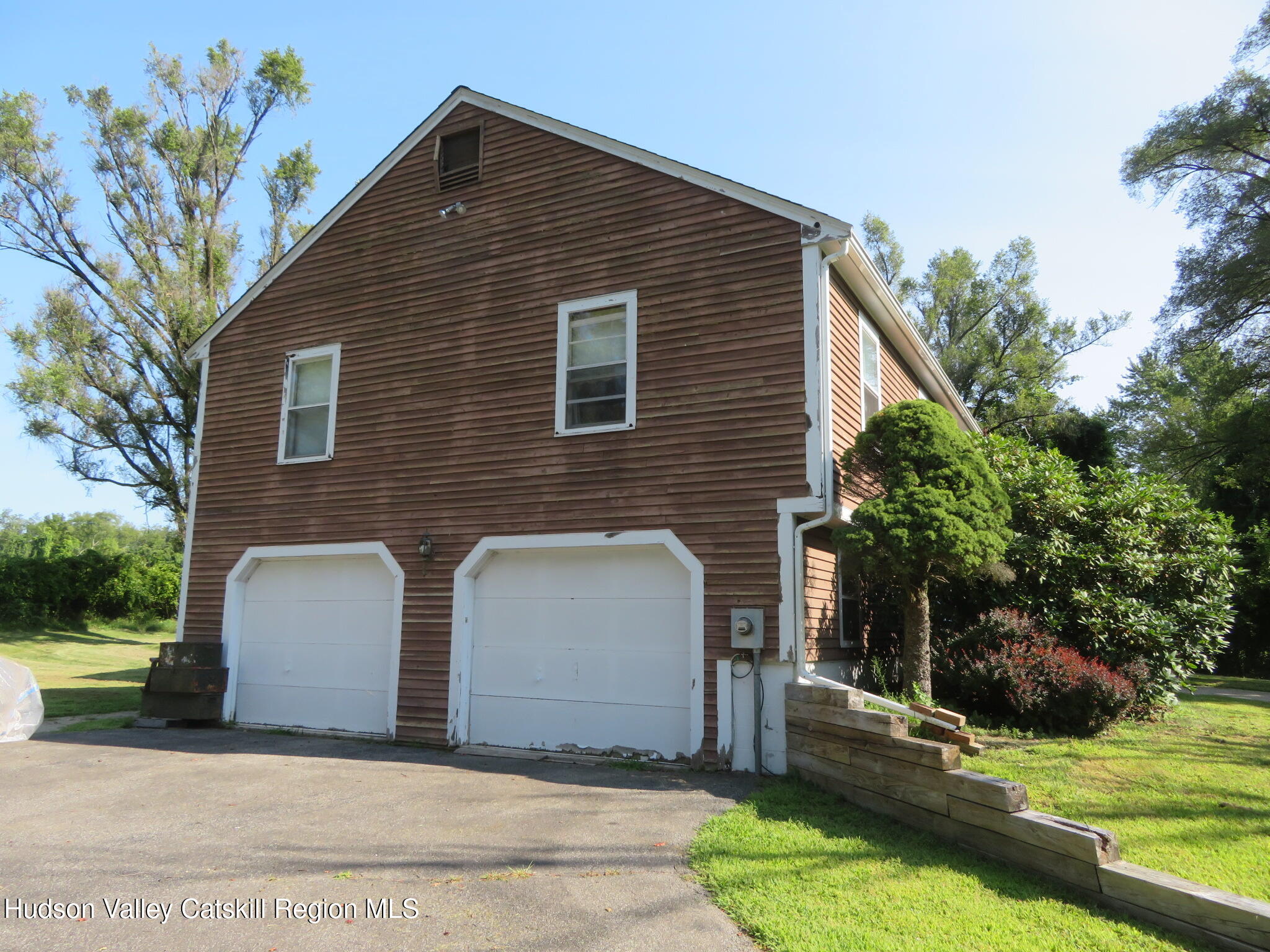 89 Vincent Lane Stone Ridge, NY 12484 - Photo 2 of 45 a front view of a house with a yard and garage