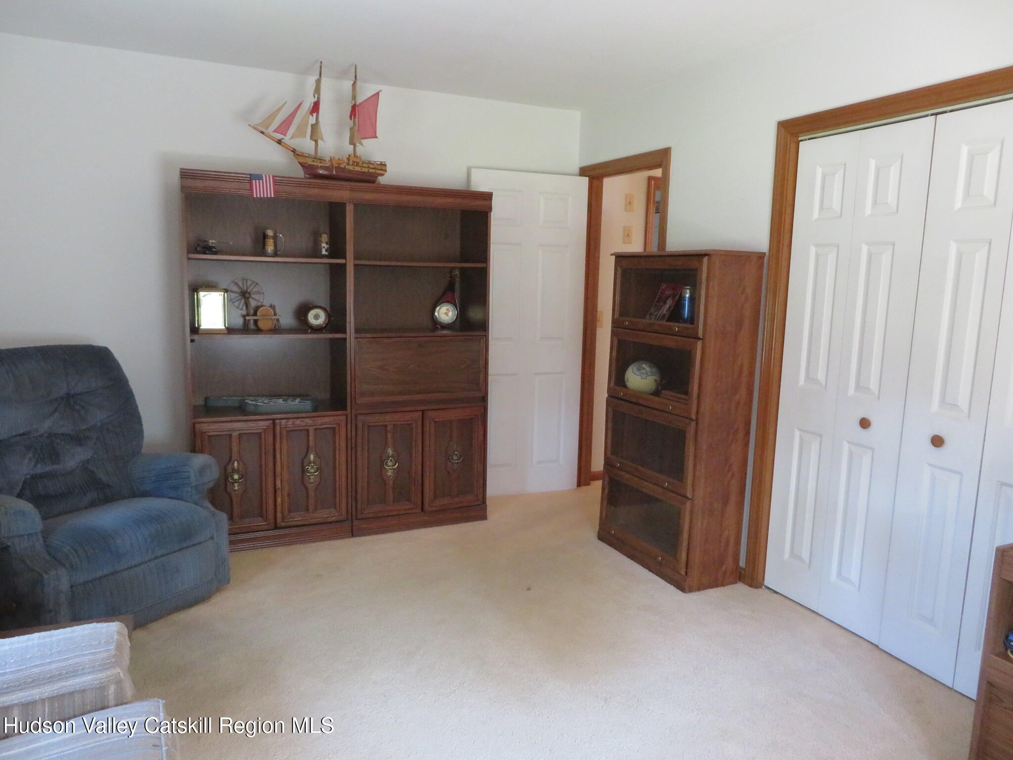 89 Vincent Lane Stone Ridge, NY 12484 - Photo 25 of 45 a living room with furniture and cabinets