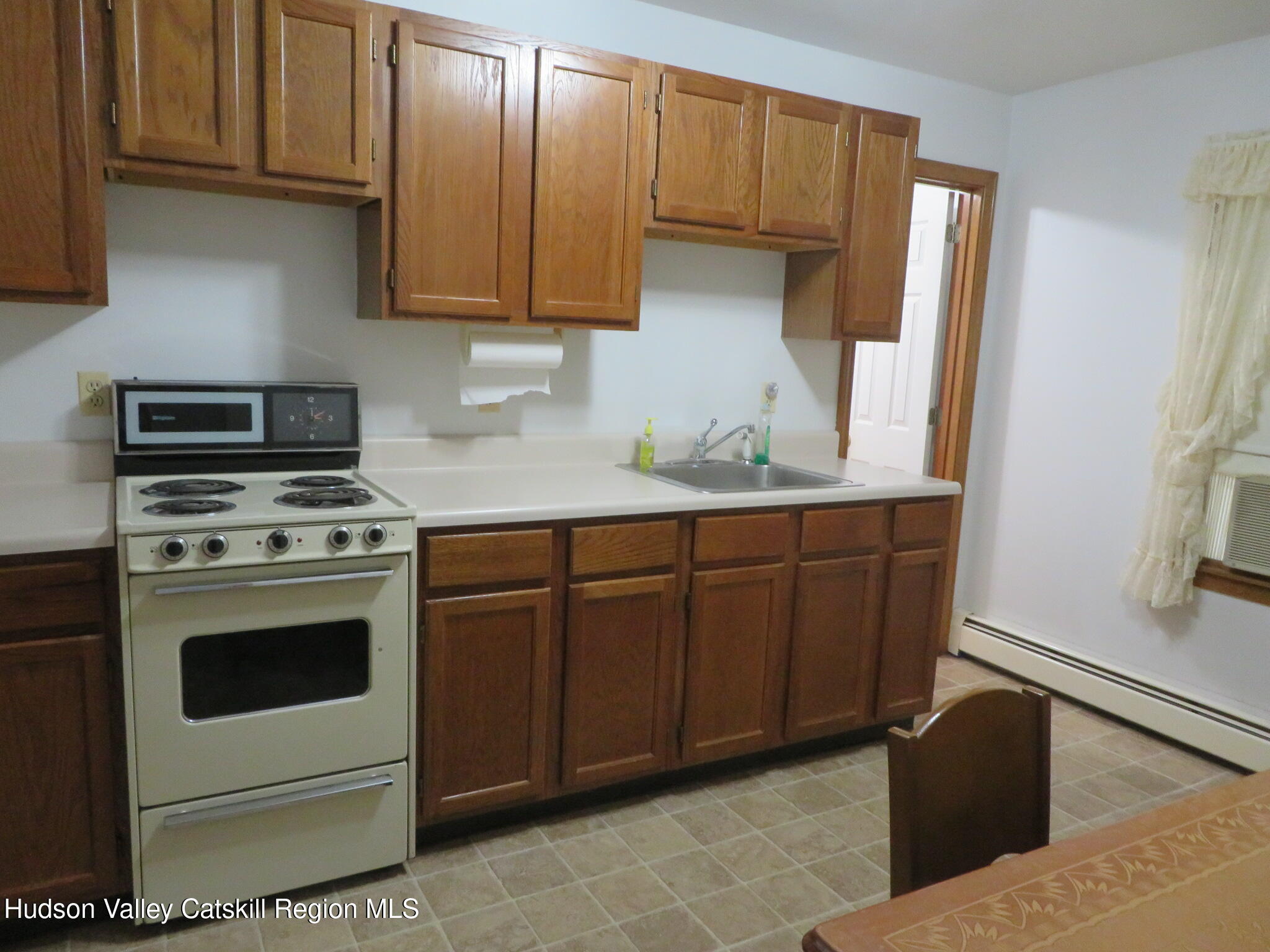 89 Vincent Lane Stone Ridge, NY 12484 - Photo 32 of 45 a kitchen with stainless steel appliances granite countertop a stove a sink and a refrigerator