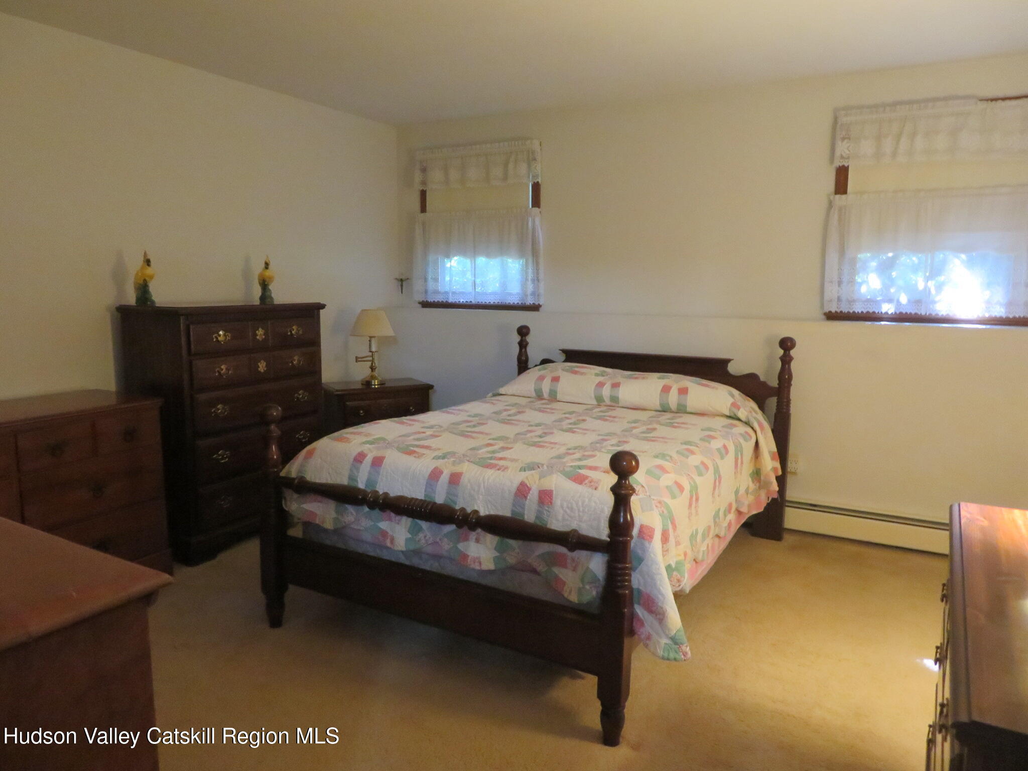 89 Vincent Lane Stone Ridge, NY 12484 - Photo 37 of 45 a bed sitting in a bedroom next to a lamp