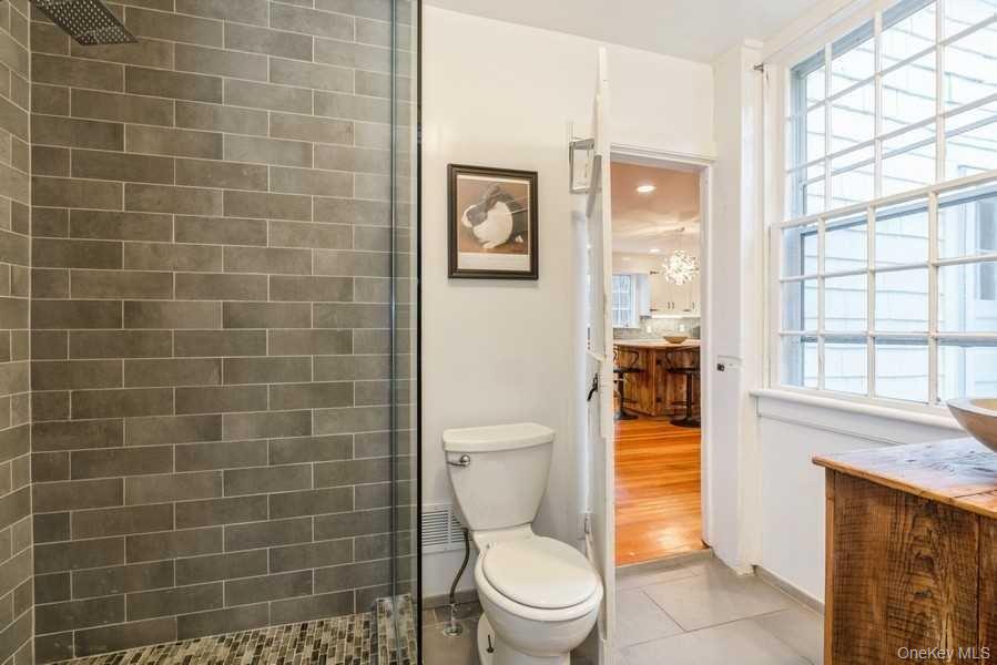 1141 Beekman Road Hopewell Junction, NY 12533 - Photo 16 of 36 a bathroom with a toilet a bath tub and a window