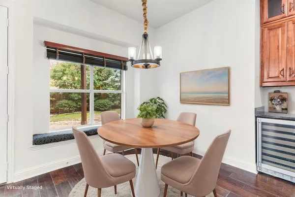 a dining room with furniture a chandelier and wooden floor