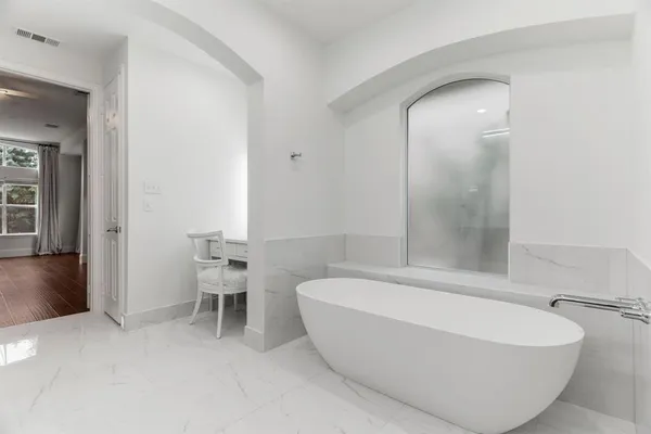a bathroom with a bathtub and a toilet