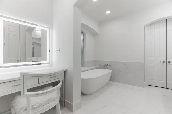 a bathroom with a double vanity sink mirror and bathtub