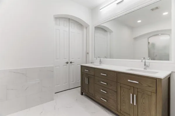 a bathroom with a double vanity sink a and mirror