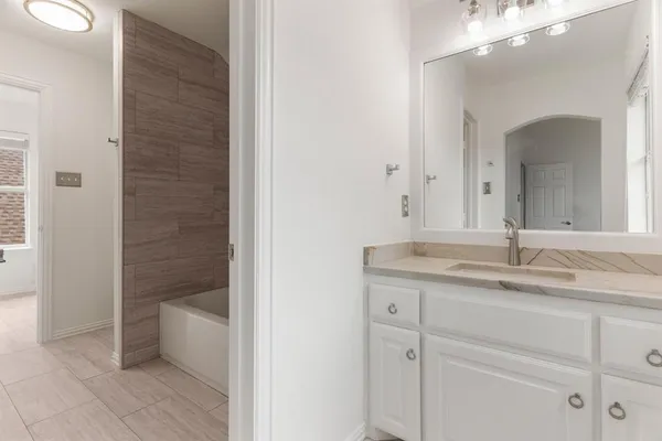 a bathroom with a granite countertop sink a toilet and shower