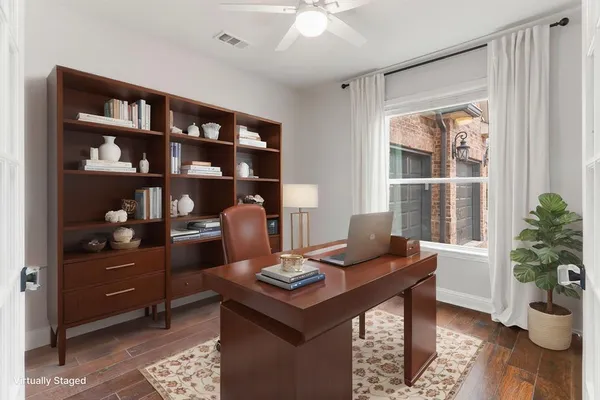 a view of a workspace with furniture and a potted plant