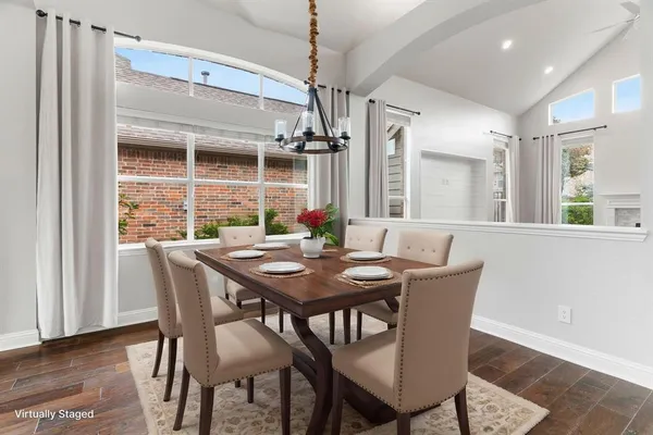 a view of a dining room with furniture window and wooden floor