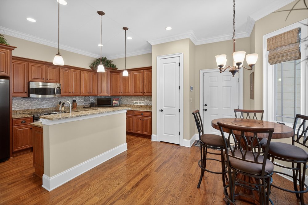 132 Regatta Drive Anderson, SC 29625 - Photo 16 of 50 This inviting kitchen and dining area features warm wood flooring and elegant pendant lighting.