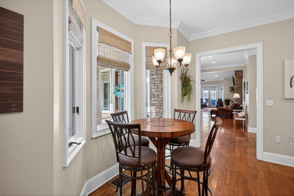 132 Regatta Drive Anderson, SC 29625 - Photo 19 of 50 This cozy dining area features beautiful wood flooring and elegant crown molding, creating an inviting atmosphere overlooking the beautiful court yard
