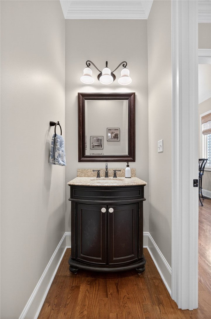 132 Regatta Drive Anderson, SC 29625 - Photo 24 of 50 This cozy powder room features elegant fixtures and rich hardwood flooring.