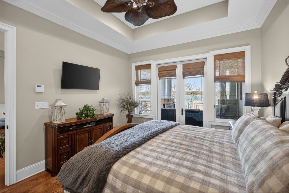 132 Regatta Drive Anderson, SC 29625 - Photo 26 of 50 This serene bedroom offers tranquil views, a ceiling fan, and access to an outdoor space.