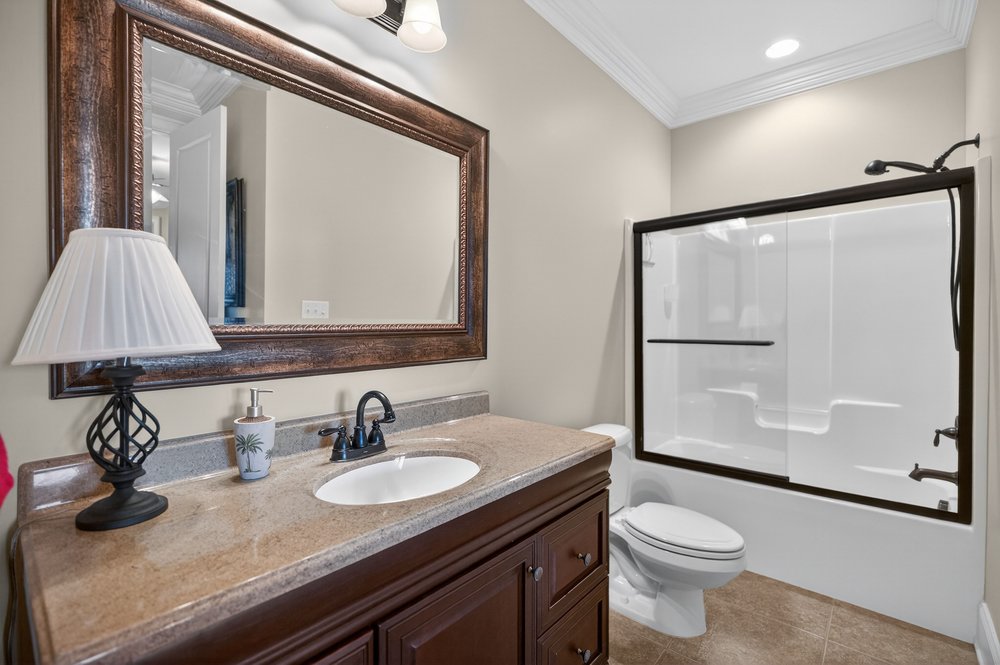 132 Regatta Drive Anderson, SC 29625 - Photo 32 of 50 This bright bathroom features a spacious vanity with an elegant framed mirror and a convenient shower-tub combination.