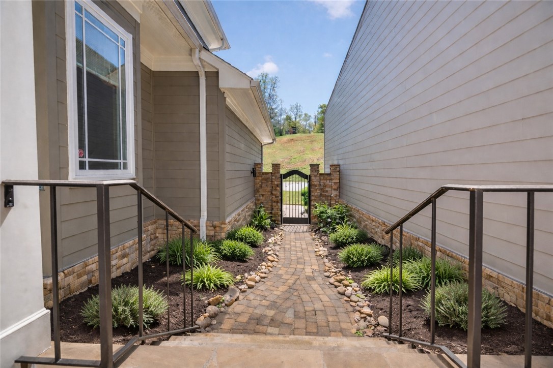 132 Regatta Drive Anderson, SC 29625 - Photo 5 of 50 This charming walkway with a decorative gate offers a private and inviting entrance.