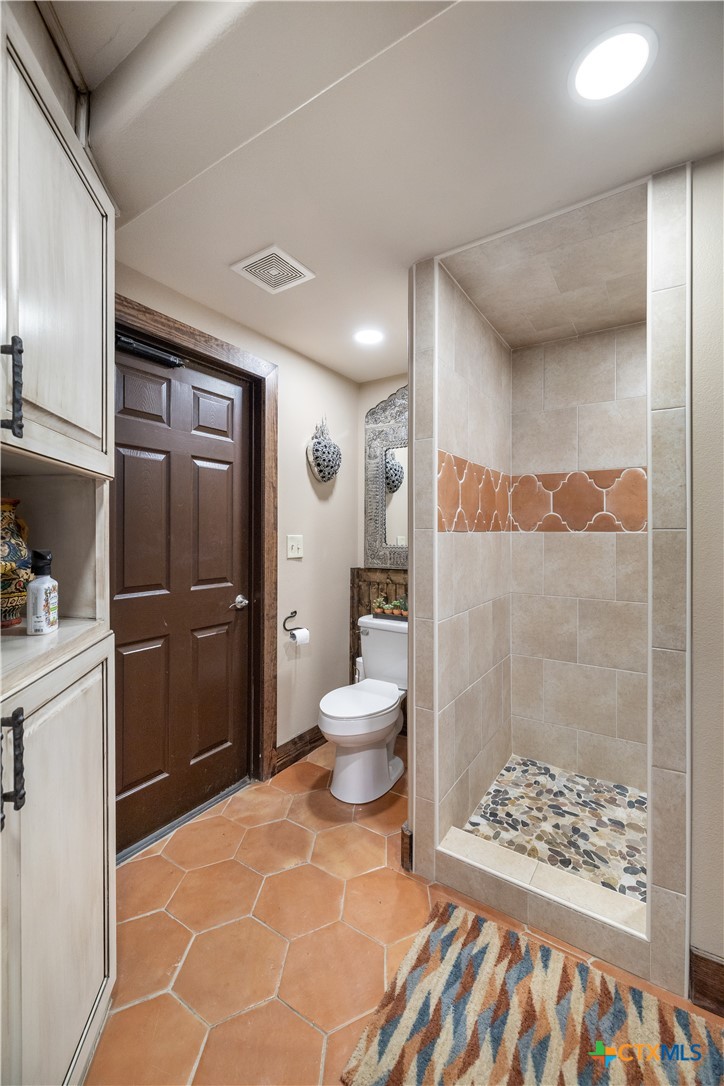 2796 Benbow Road Inez, TX 77968 - Photo 25 of 35 a bathroom with a toilet and a shower