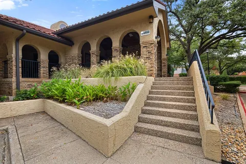 a front view of a house with plants