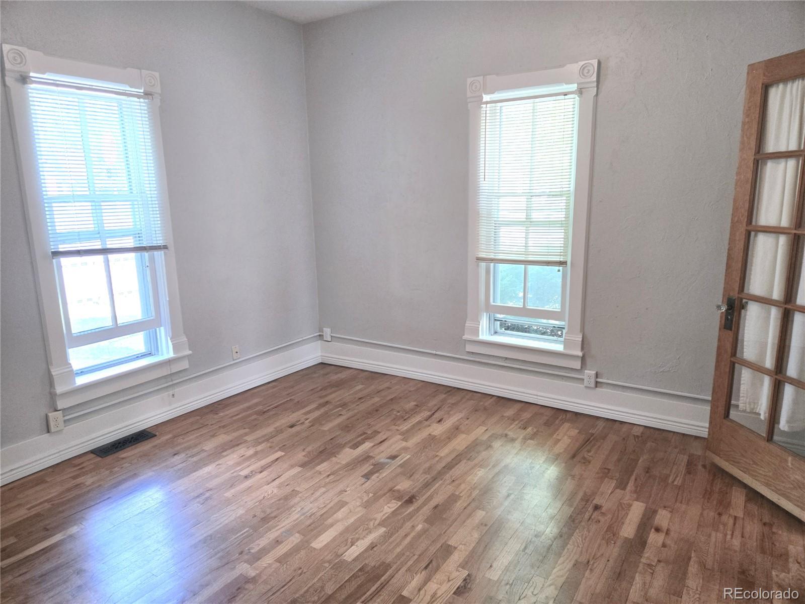 1902 Grove Street Boulder, CO 80302 - Photo 11 of 38 an empty room with wooden floor and windows