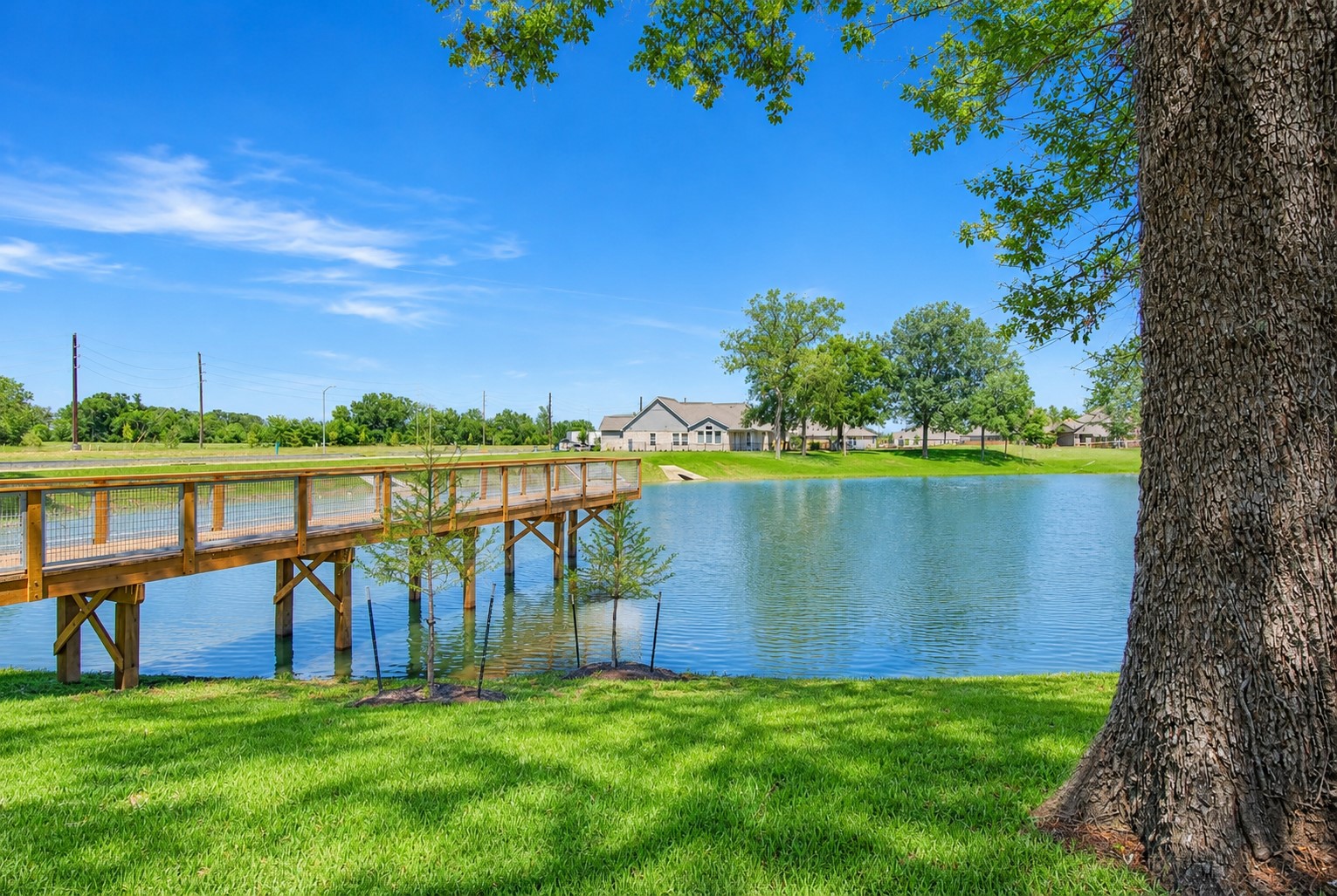 32607 Fly Fish Way Fulshear, TX 77441 - Photo 38 of 41 This photo captures a view of the home from across the lake and showcases this remarkable pier that extends far out into the lake and is ideal for fishing or simply watching a later afternoon sunset.