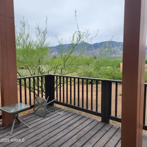a view of balcony with furniture and wooden floor