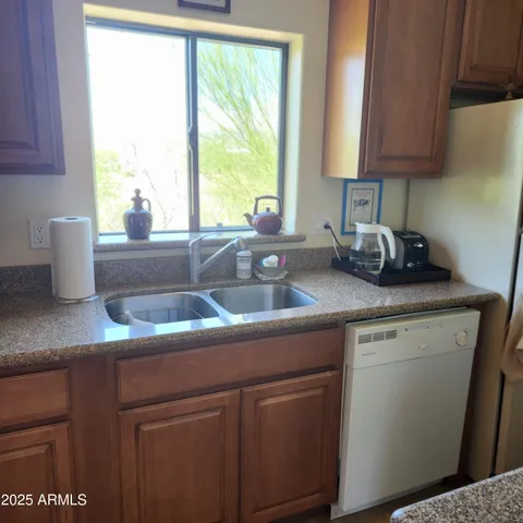 a kitchen with stainless steel appliances granite countertop a stove and a sink