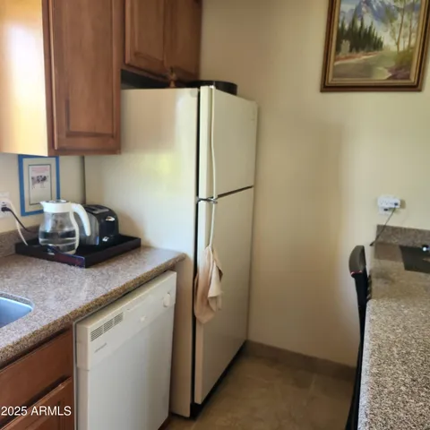 a view of a sink a microwave and wooden floor