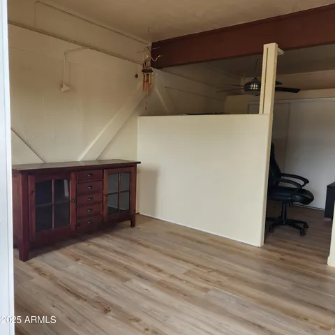 a bath room with a table chair and a window