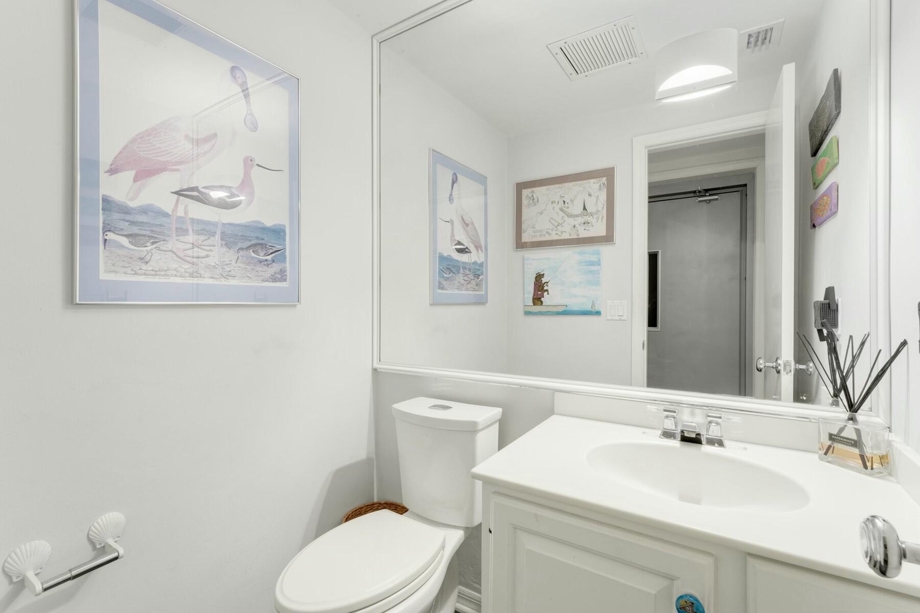 33 Pen Key Drive Islamorada, FL 33036 - Photo 25 of 60 a bathroom with a toilet a sink and mirror