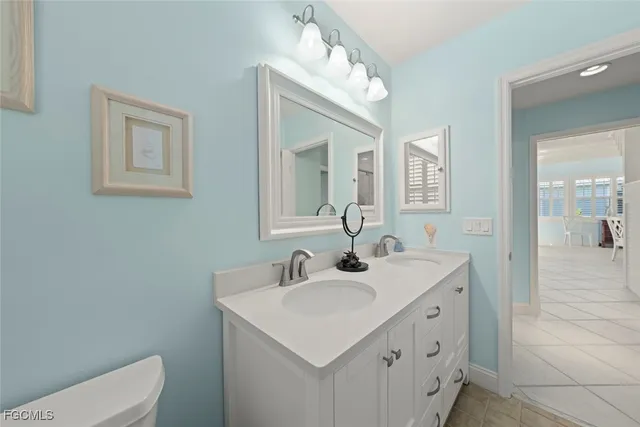 a bathroom with a sink toilet and mirror