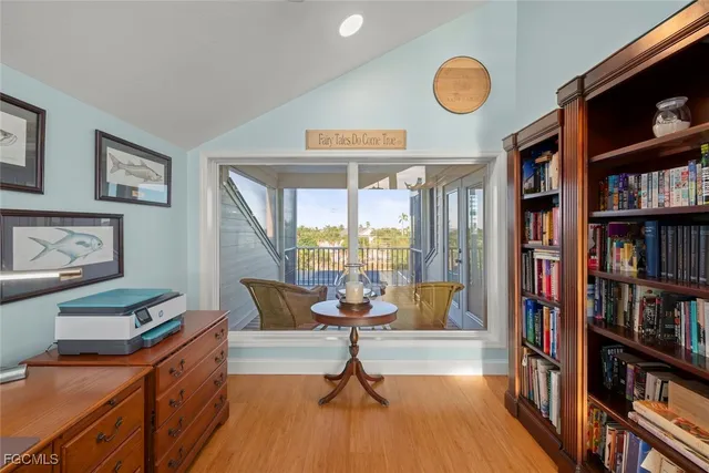 a living room with lots of furniture and a book shelf