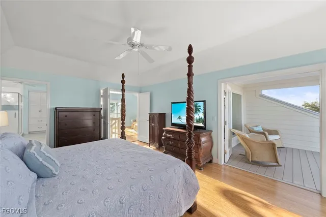 a bedroom with a bed and dresser with chair