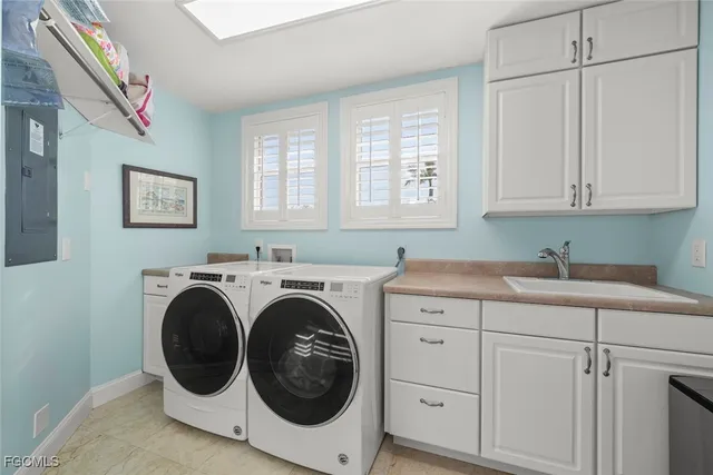 a utility room with sink dryer and washer