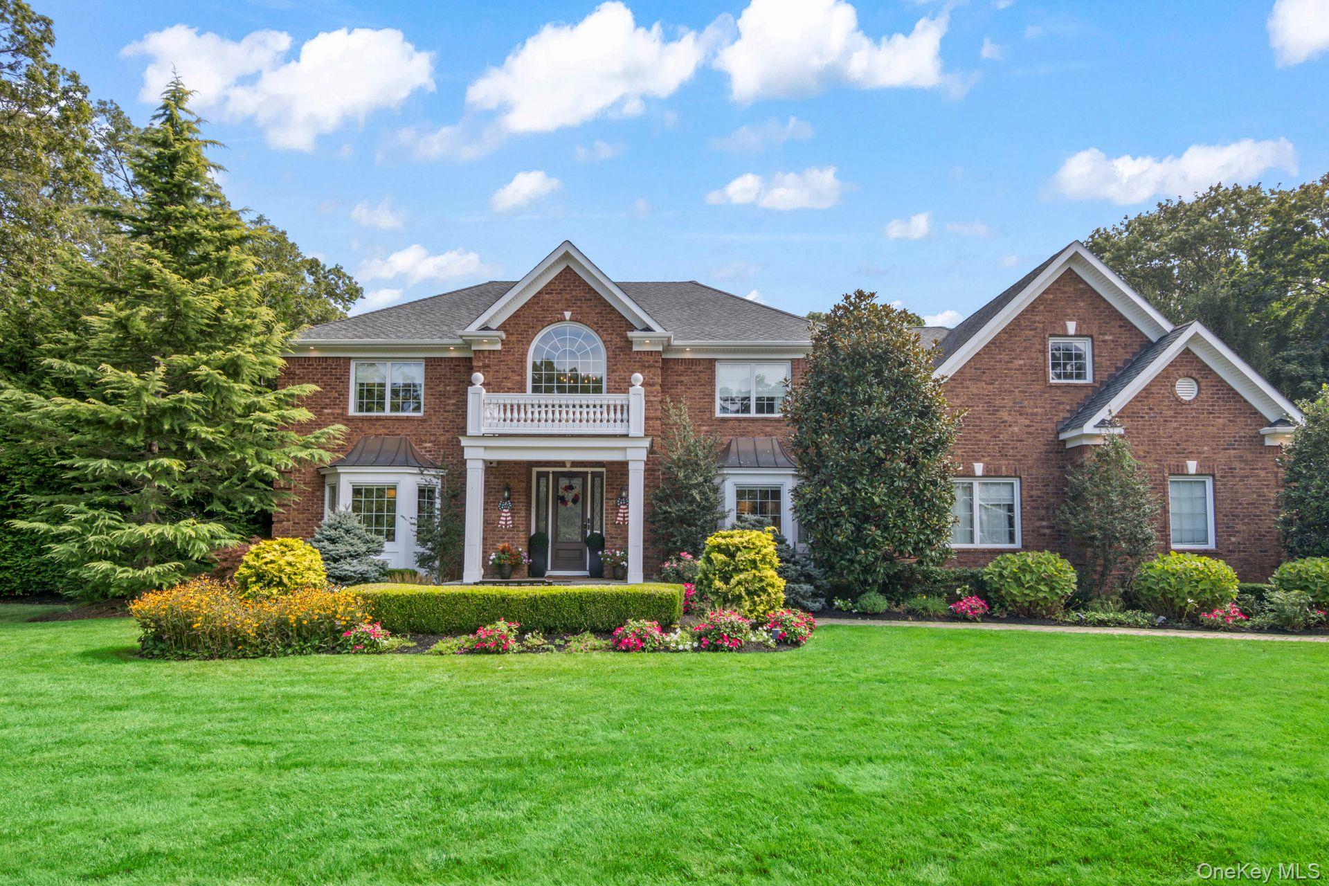 87 Mayfair Road Nesconset, NY 11767 - Photo 1 of 1 Colonial house with brick siding, a front yard, and a balcony