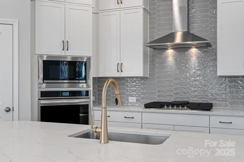 a kitchen with cabinets and stainless steel appliances
