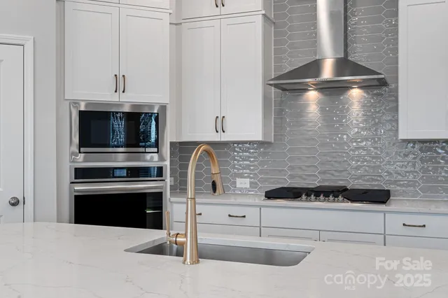 a kitchen with cabinets and stainless steel appliances