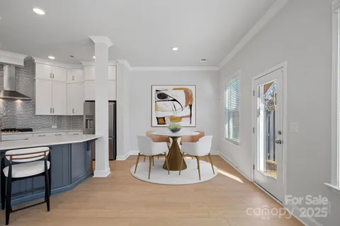 a large white kitchen with a table and chairs