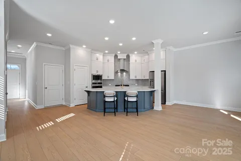 a view of kitchen with kitchen island dining table and wooden floor