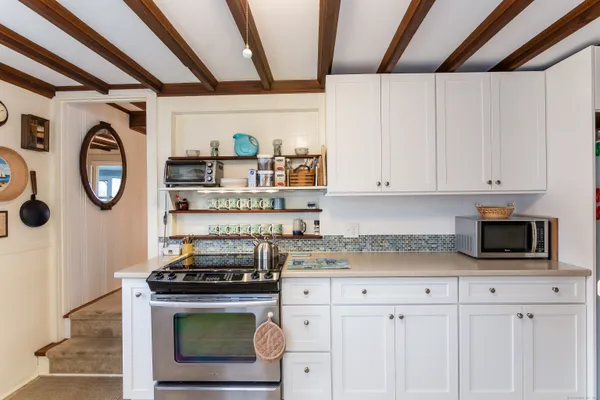 a stove top oven sitting inside of a kitchen