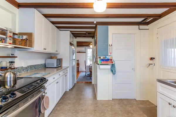 a kitchen with a sink and a stove top oven