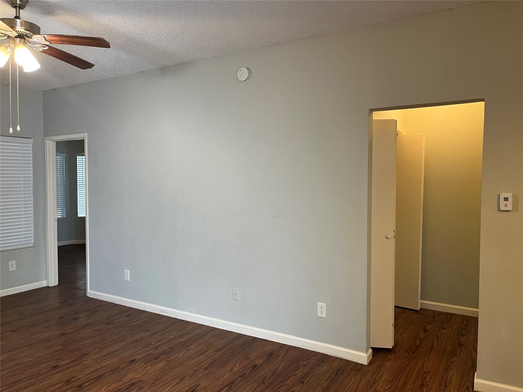 9502 Kempler Drive, Unit B Austin, TX 78748 - Photo 6 of 18 Empty room with ceiling fan, wood finished floors, and a textured ceiling