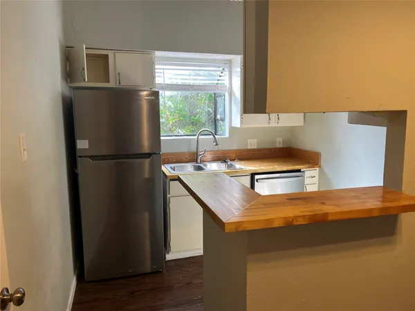a kitchen with a refrigerator and a sink