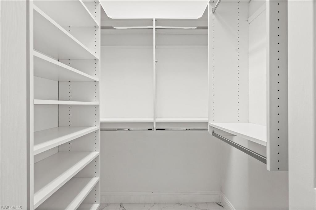 3972 Ruxton Road Naples, FL 34116 - Photo 23 of 41 a view of walk in closet with empty racks