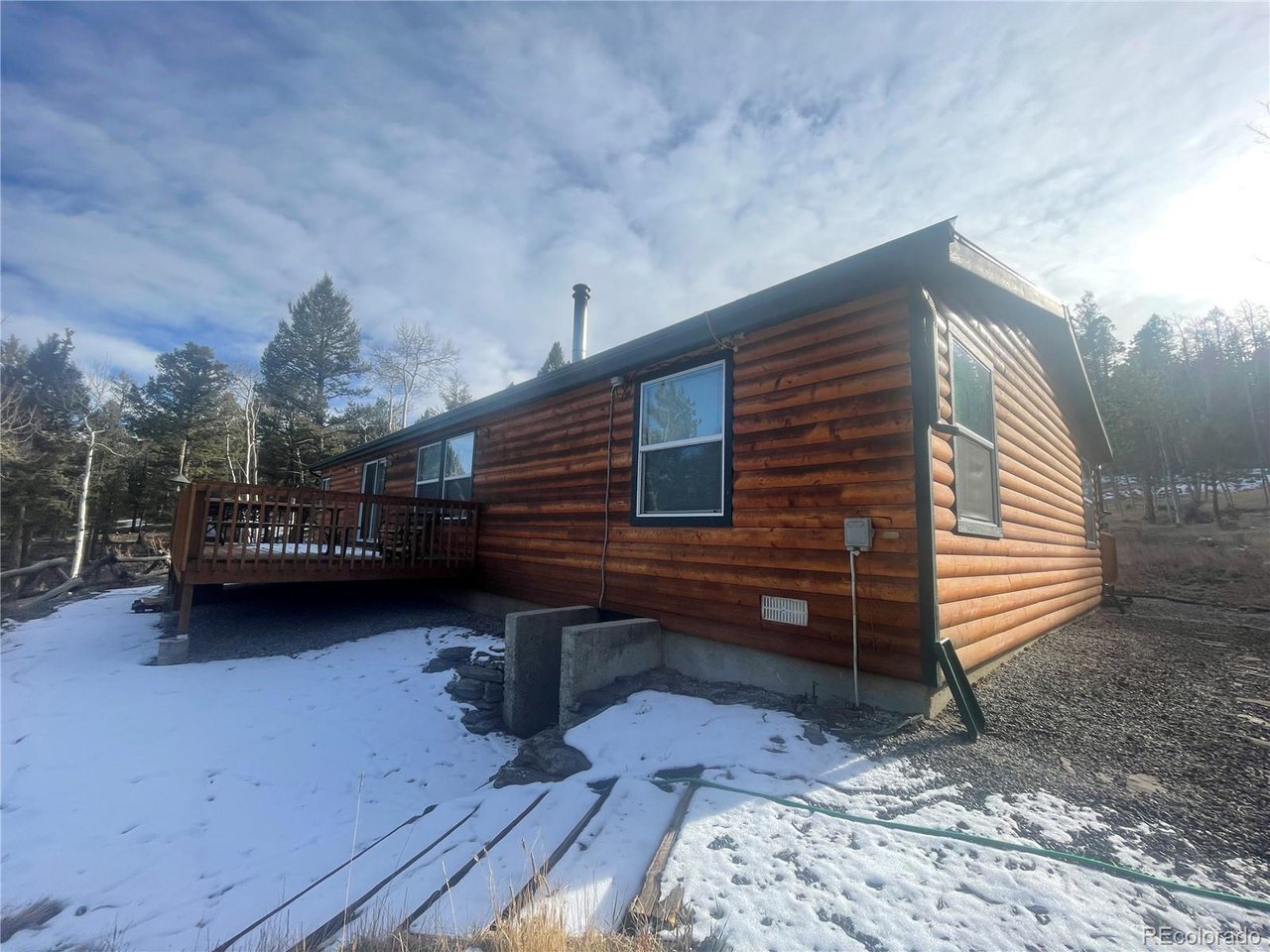 663 Bellows Road Hartsel, CO 80449 - Photo 3 of 32 a backyard of a house with barbeque oven and outdoor seating