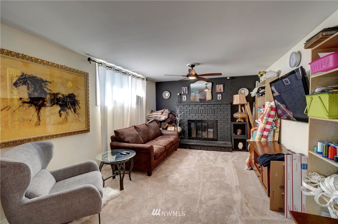 16116 119th Avenue Southeast Renton, WA 98058 - Photo 11 of 20 a living room with furniture and a fireplace