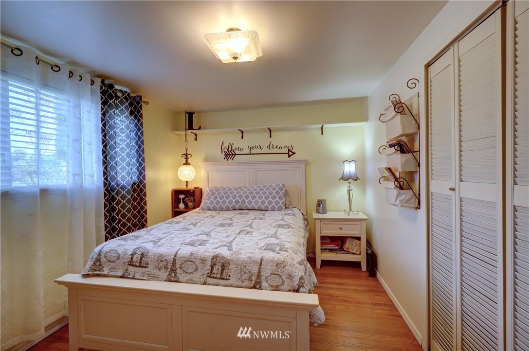 16116 119th Avenue Southeast Renton, WA 98058 - Photo 12 of 20 a bedroom with a bed and a mirror