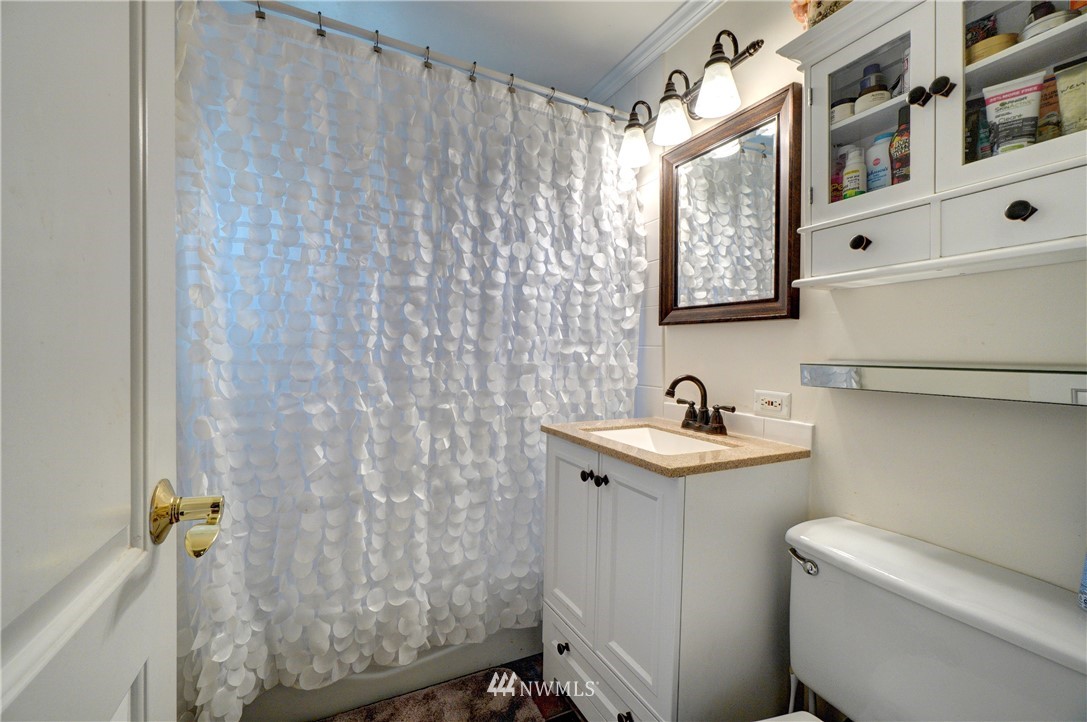 16116 119th Avenue Southeast Renton, WA 98058 - Photo 13 of 20 a bathroom with a sink toilet and shower