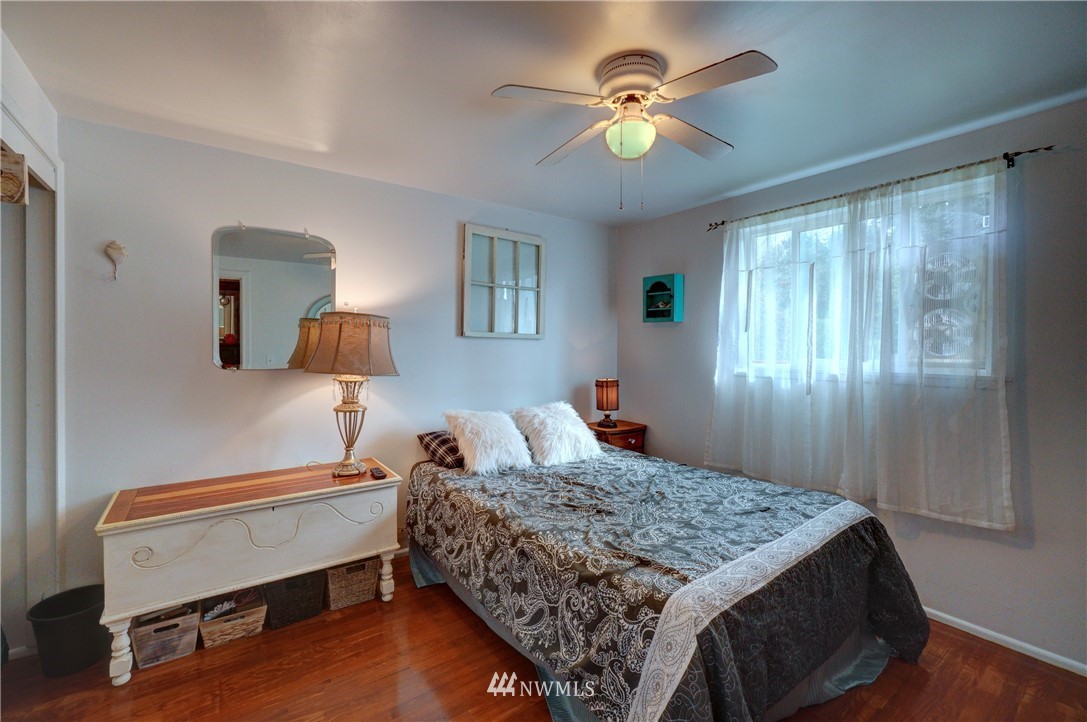 16116 119th Avenue Southeast Renton, WA 98058 - Photo 14 of 20 a bedroom with a bed and a chandelier