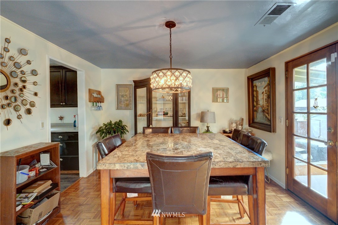 16116 119th Avenue Southeast Renton, WA 98058 - Photo 6 of 20 a view of a dining room with furniture window and wooden floor