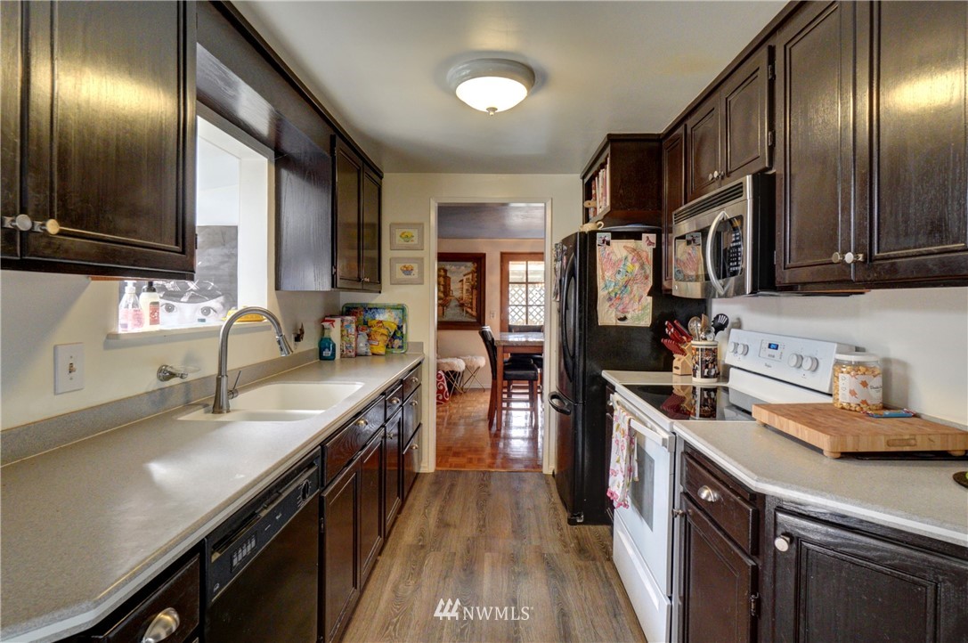 16116 119th Avenue Southeast Renton, WA 98058 - Photo 7 of 20 a kitchen with a sink stove and cabinets