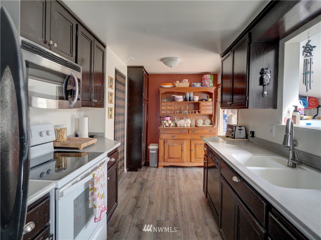 16116 119th Avenue Southeast Renton, WA 98058 - Photo 9 of 20 a kitchen with stainless steel appliances granite countertop a sink stove and refrigerator